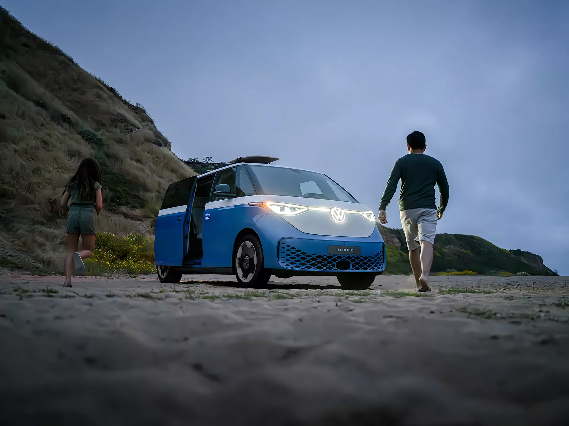Volkswagen ID. Buzz at the beach with headlights on during a Gulf Coast evening
